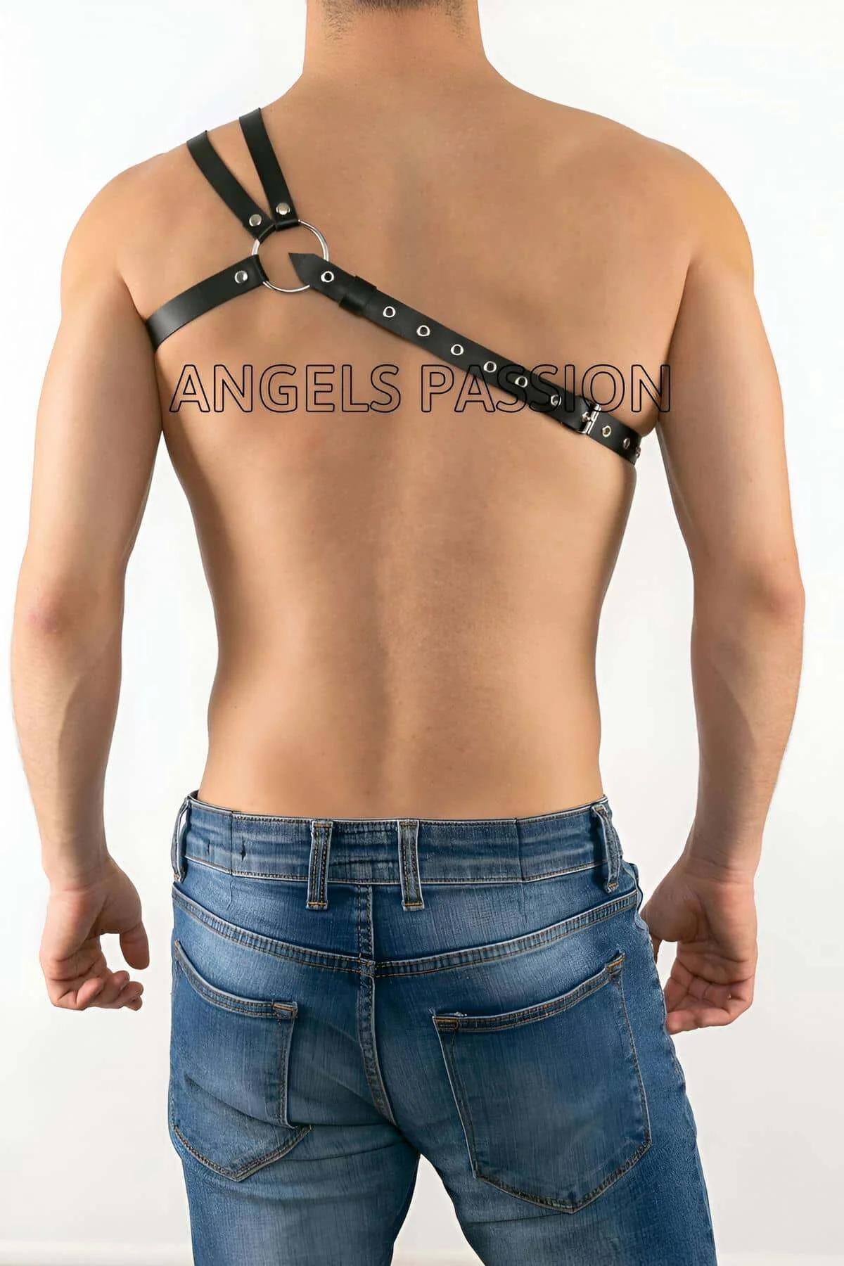 close-up of silver O-ring intersection on black faux leather chest harness straps