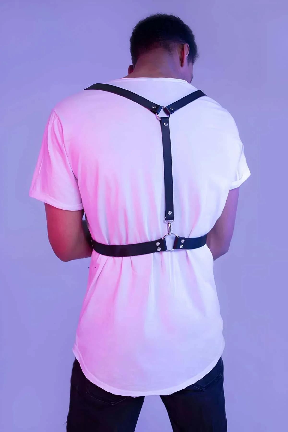 Black PU faux leather shoulder straps descending to silver buckle waistband, front view detail