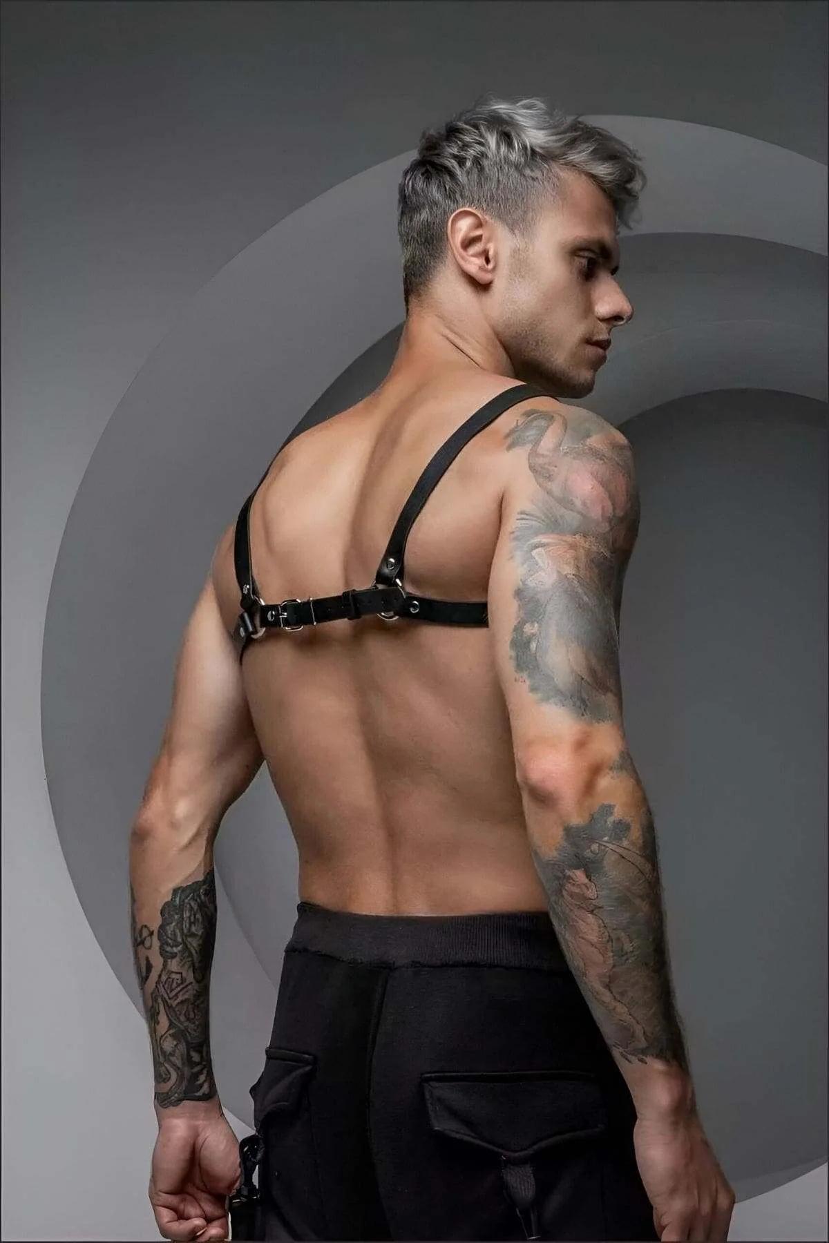 mens black chest harness layered over dark cargo pants festival outfit