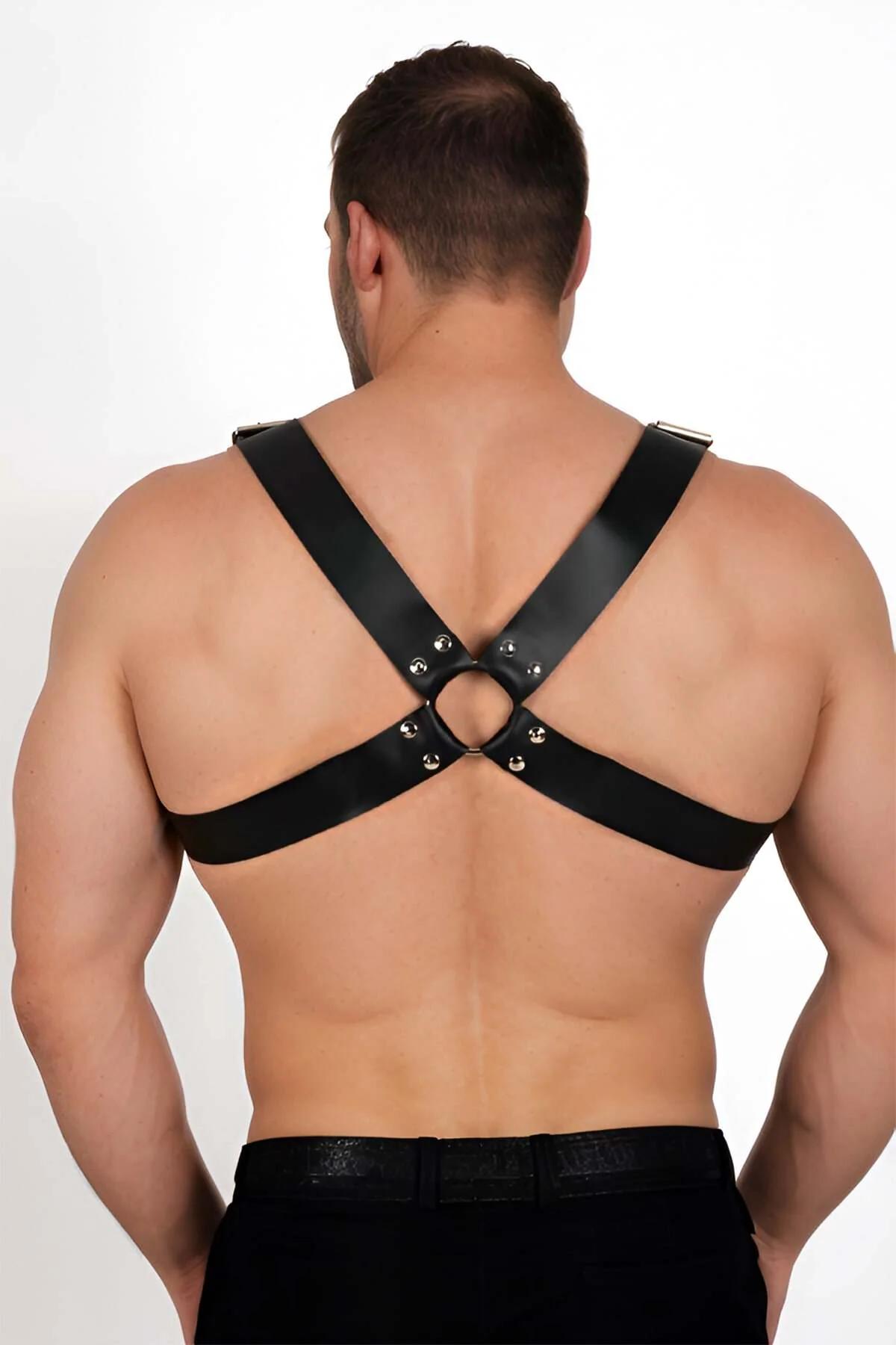side view of black faux leather chest harness showing rectangular buckle adjusters on shoulder straps