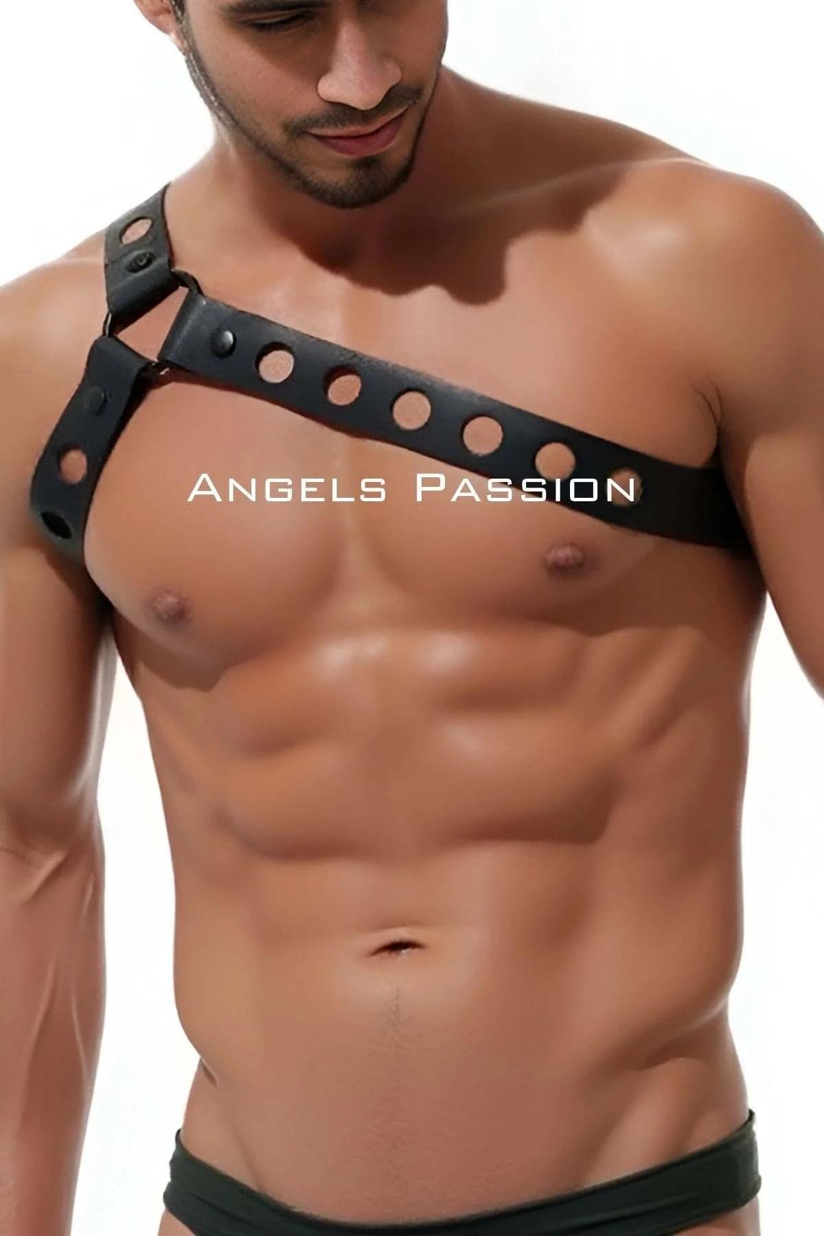 close-up of black faux leather strap with circular grommet punch-outs spaced along diagonal chest harness
