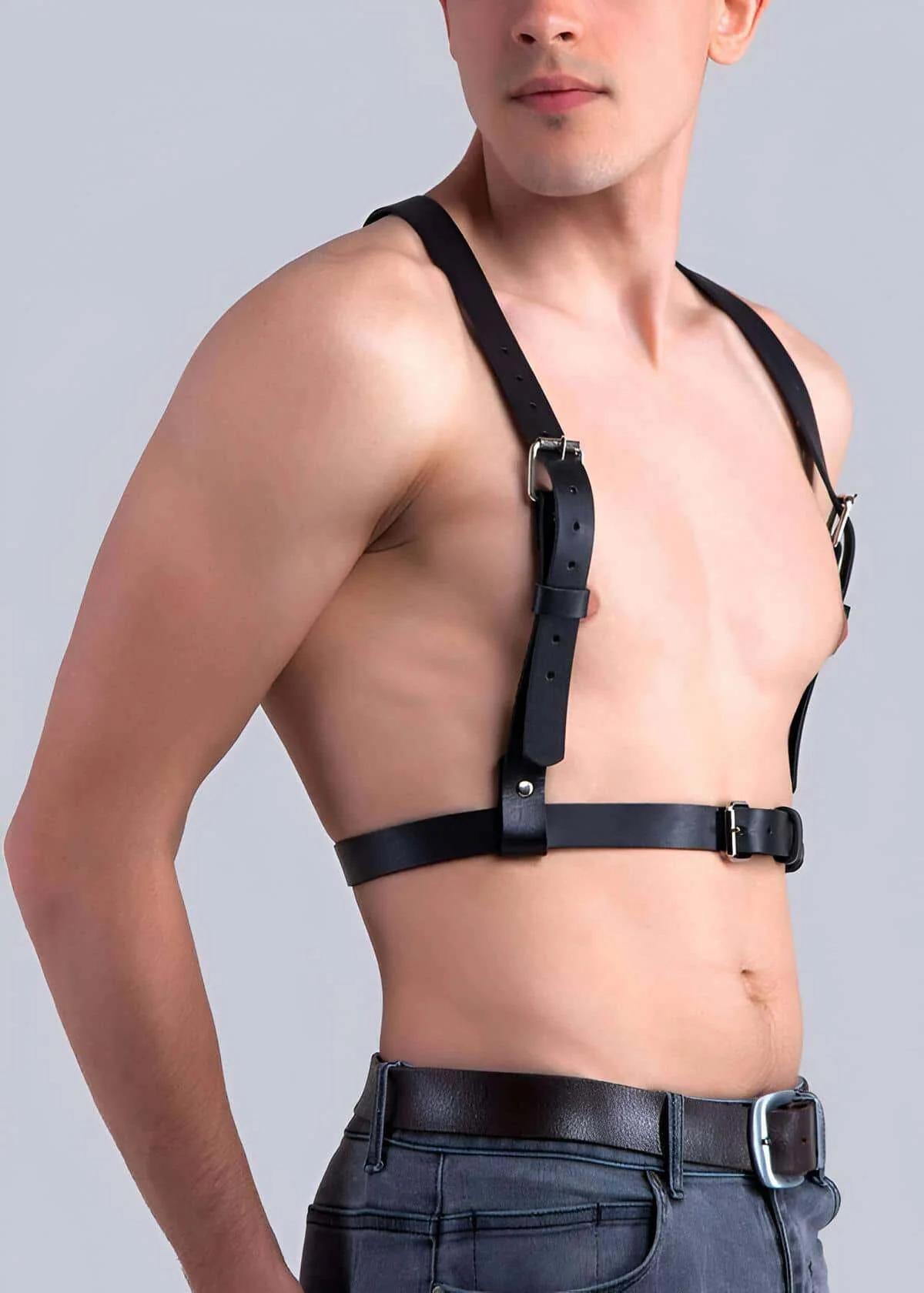 close-up of silver pin buckle on black vegan leather chest harness strap detail