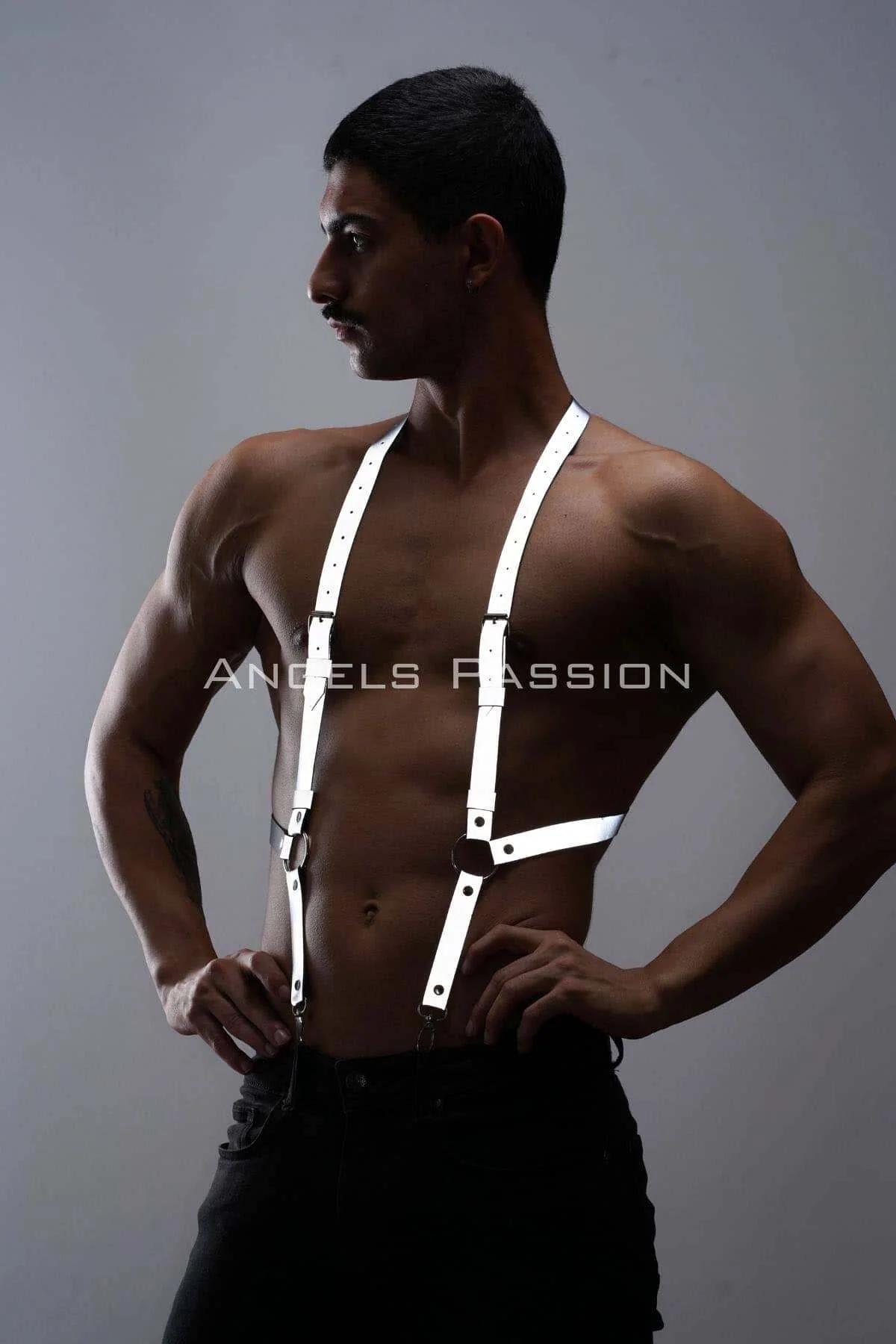 Close-up of silver O-ring junction on white reflective faux leather chest harness straps