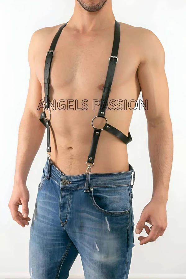 Black faux leather adjustable O-ring body harness with silver buckles and D-ring clips worn over bare chest with jeans