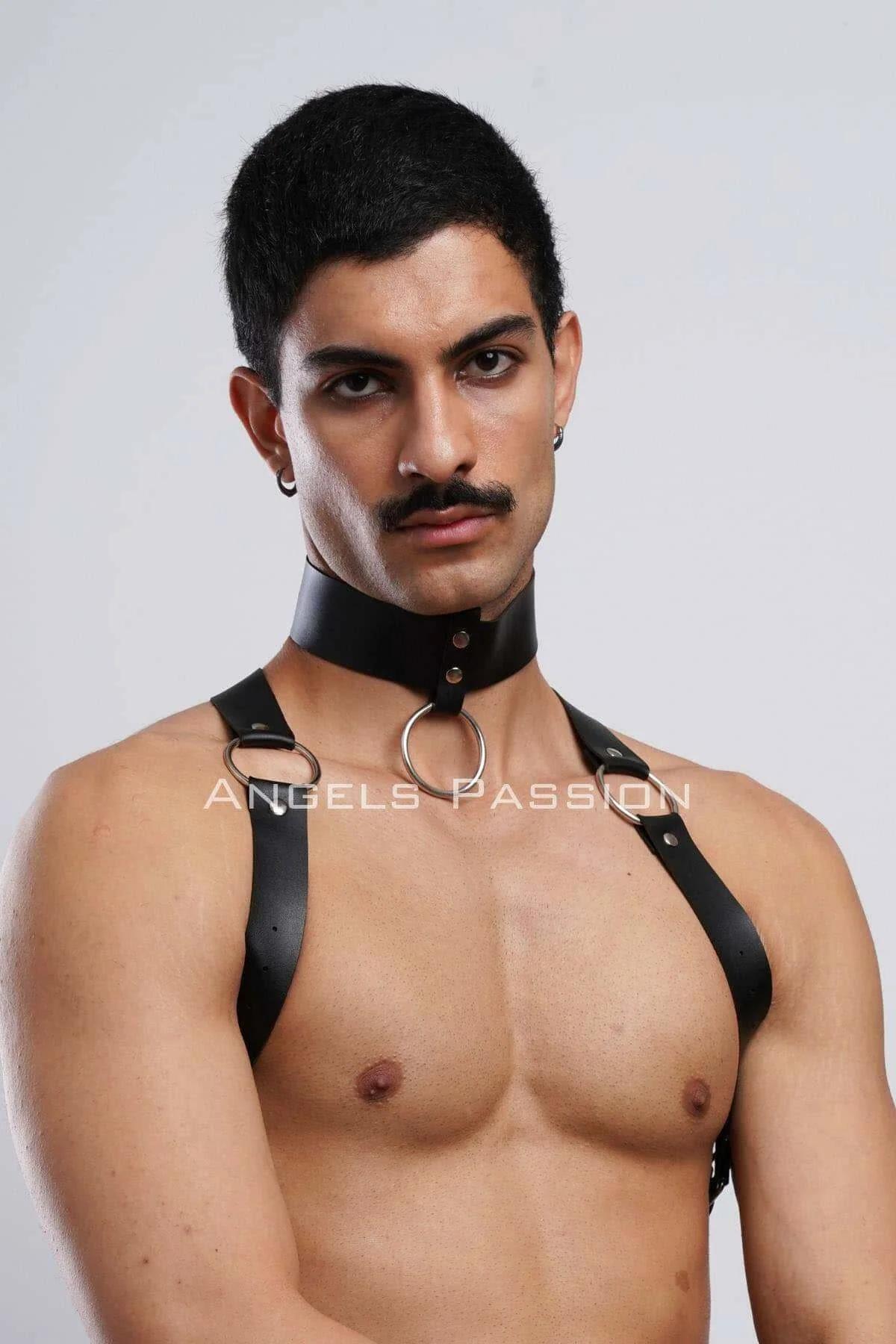 Black faux leather chest harness laid flat showing three O-ring hardware and strap width