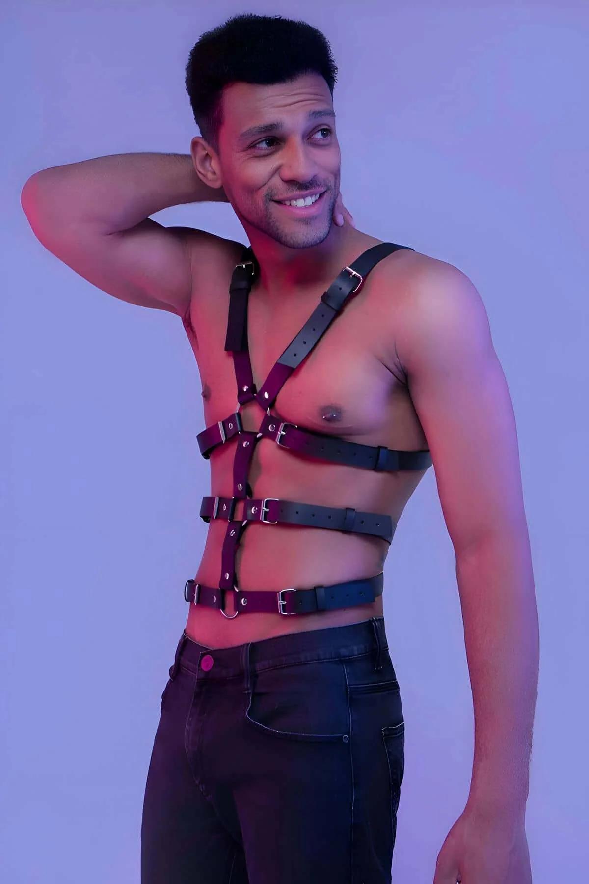 Silver O-ring detail at center chest of black faux leather full body harness