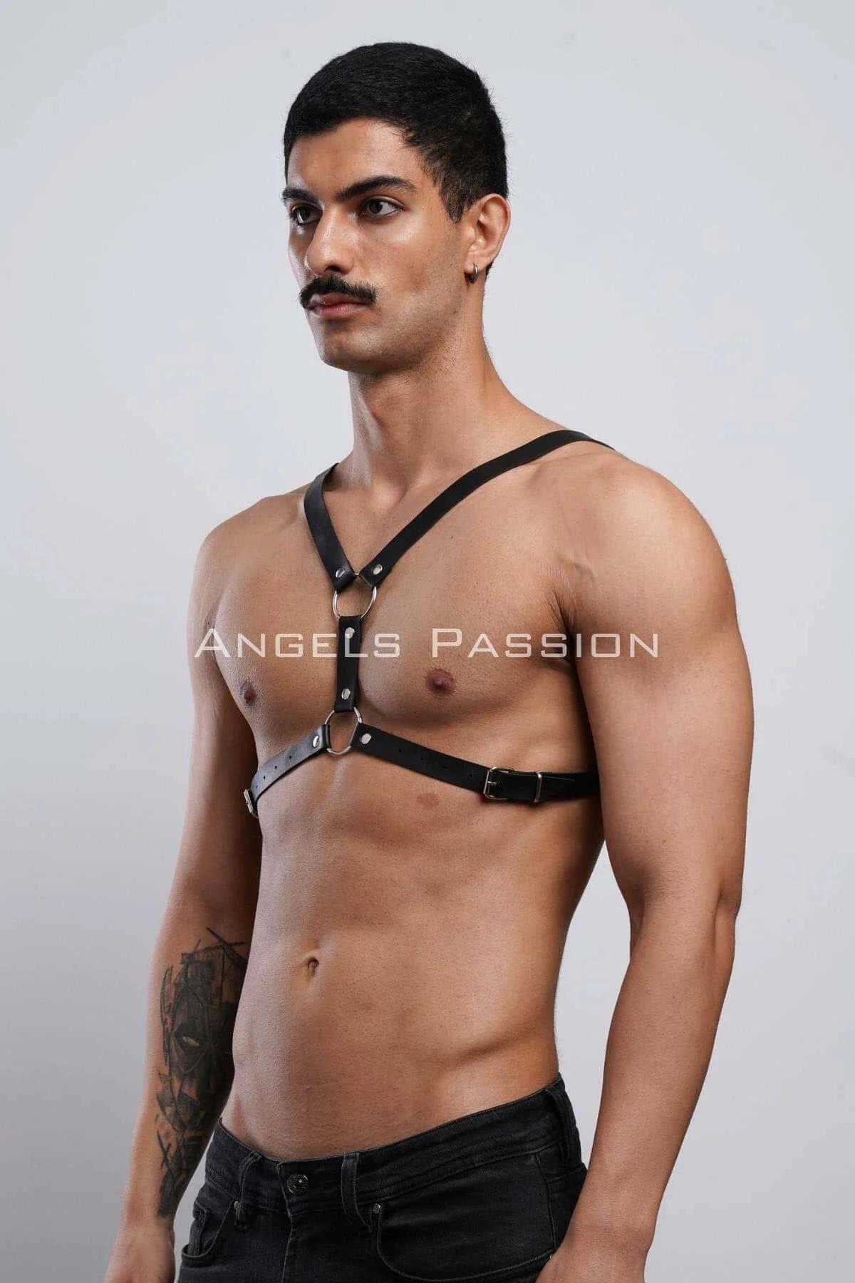 Close-up of silver O-ring and square buckle hardware on black faux leather chest harness