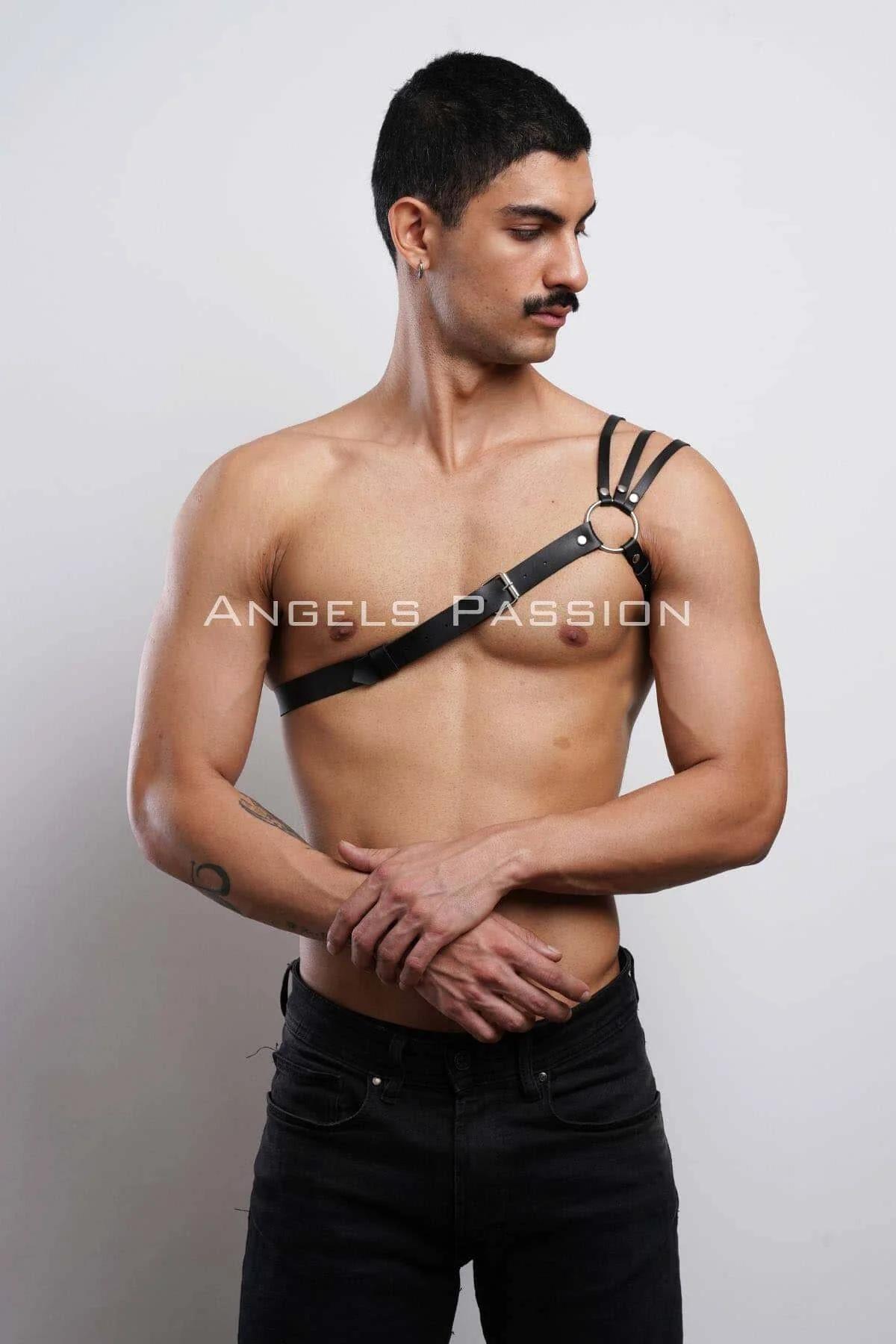 Side angle of black single strap chest harness showing pin-and-hole buckle adjustment on shoulder
