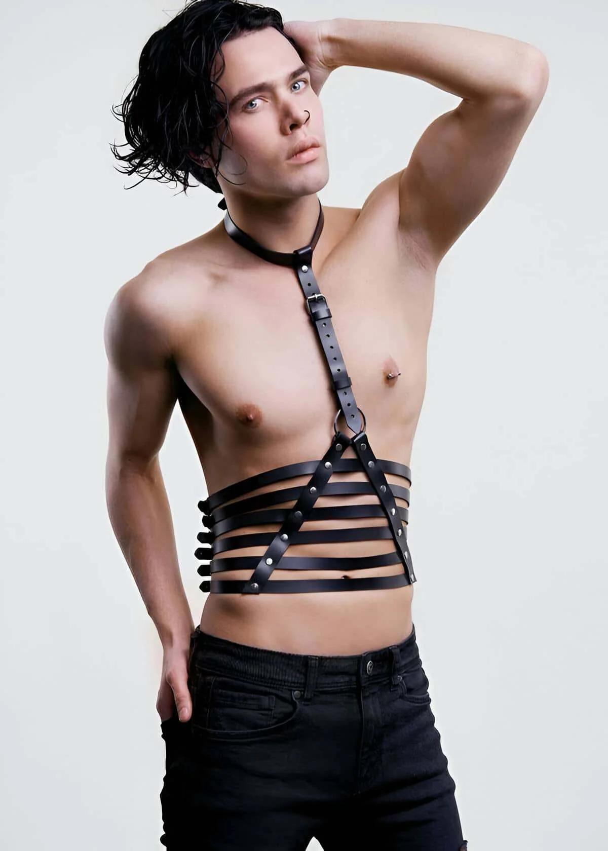 black faux leather torso harness with five-strap waist cage and adjustable neck collar on male model