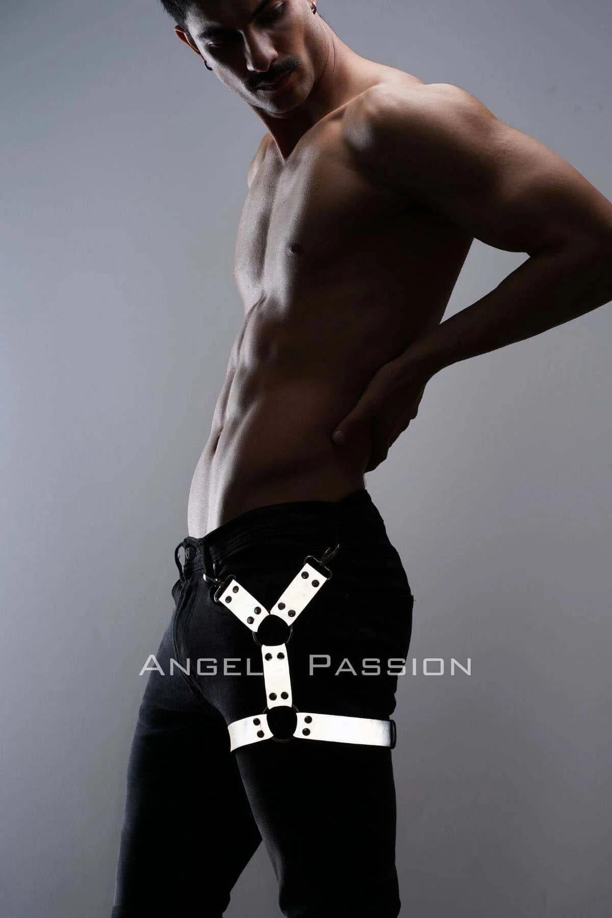 Side view of reflective white leg harness with O-ring center against black denim jeans