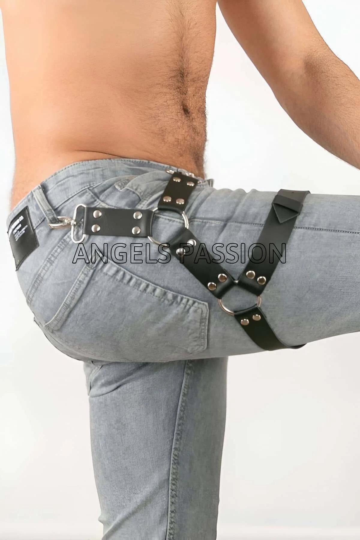 close-up of silver O-ring junction and dome-head rivets on black faux leather thigh harness straps