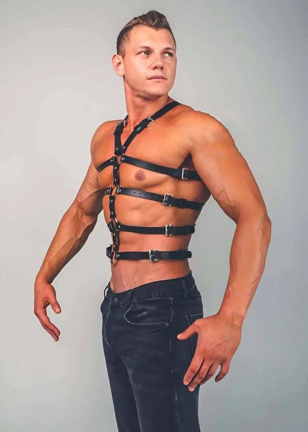 Black faux leather full body chest harness with four horizontal adjustable strap bands and silver buckles on male model
