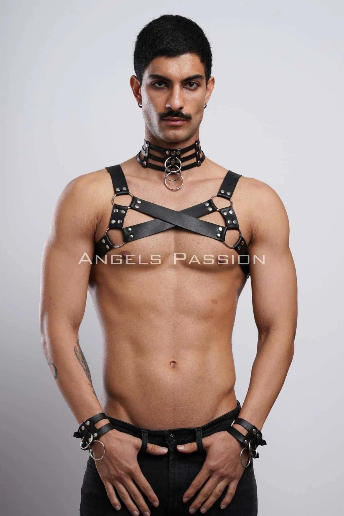 Close-up of black PU leather X-cross chest harness with silver stud rivets and O-ring connectors
