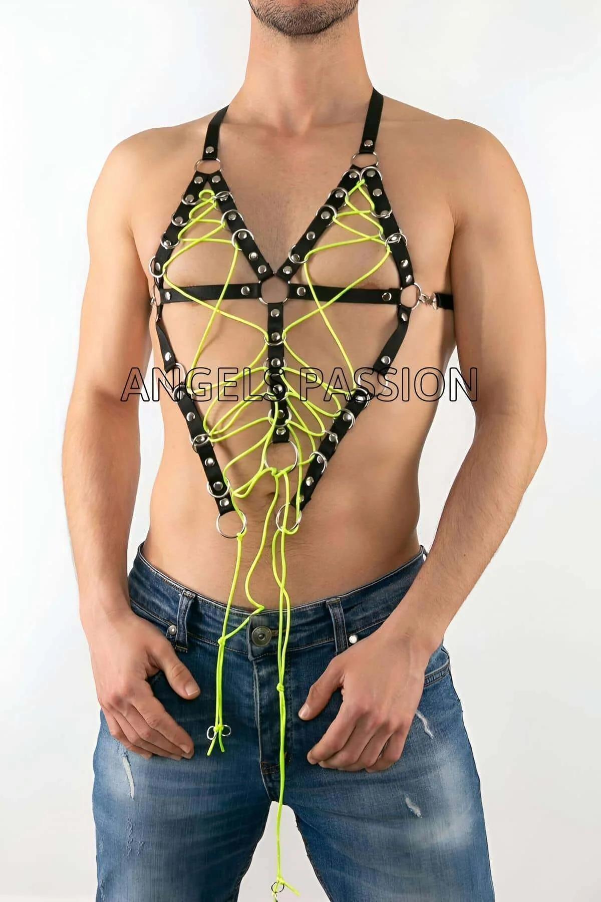 close-up of silver stud eyelets and neon green rope lacing on black faux leather cage harness chest panel