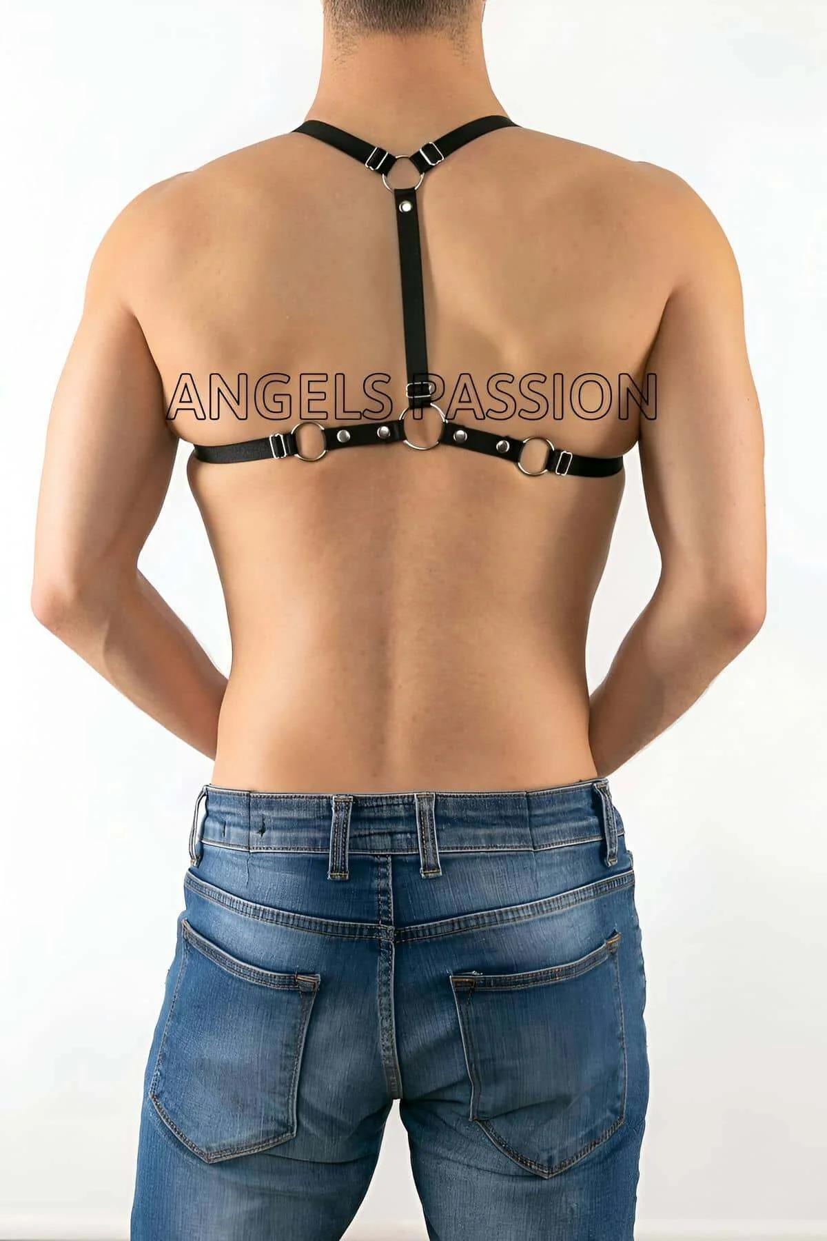 side view of black strappy faux leather harness showing open-side construction and silver rivet hardware