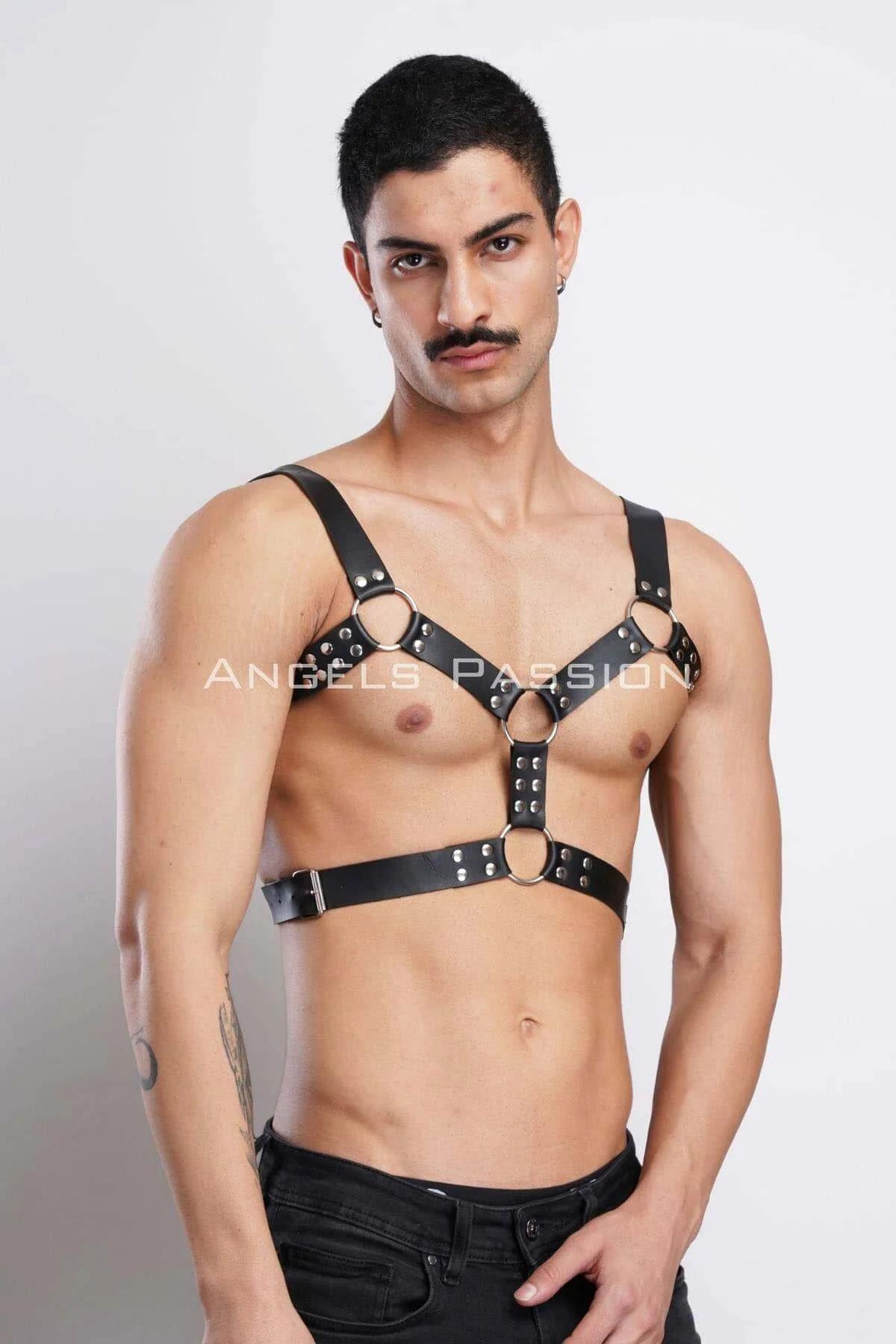 Close-up of silver dome studs lining the 2 cm-wide black faux leather shoulder straps
