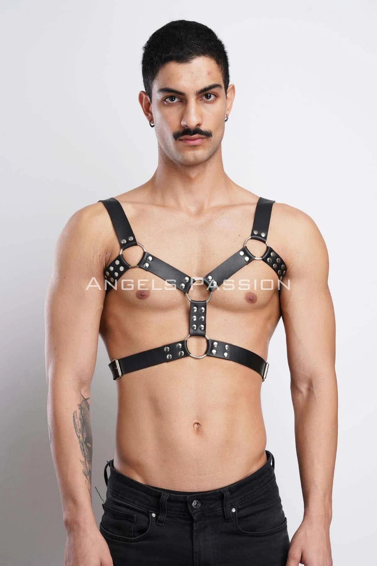 Silver O-ring detail at center chest junction of black studded faux leather harness