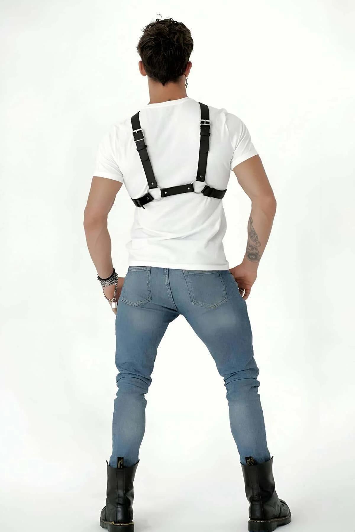 Close-up of silver pin buckle and X-cross junction on black PU leather suspender harness
