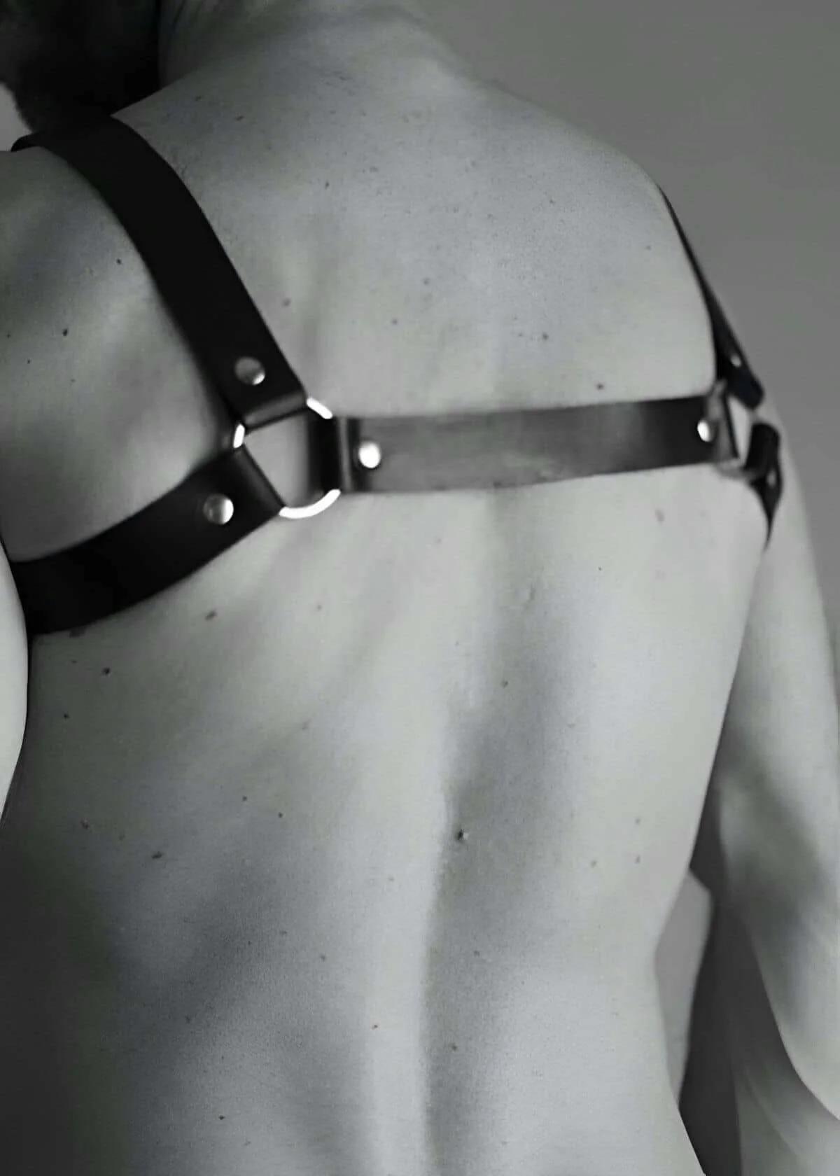 back view of adjustable black vegan leather chest harness showing shoulder strap routing and buckle adjusters