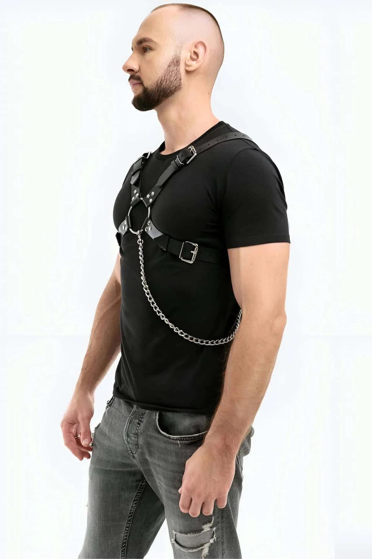 Close-up of silver O-ring center and stud rivet detail on black faux leather chest harness straps