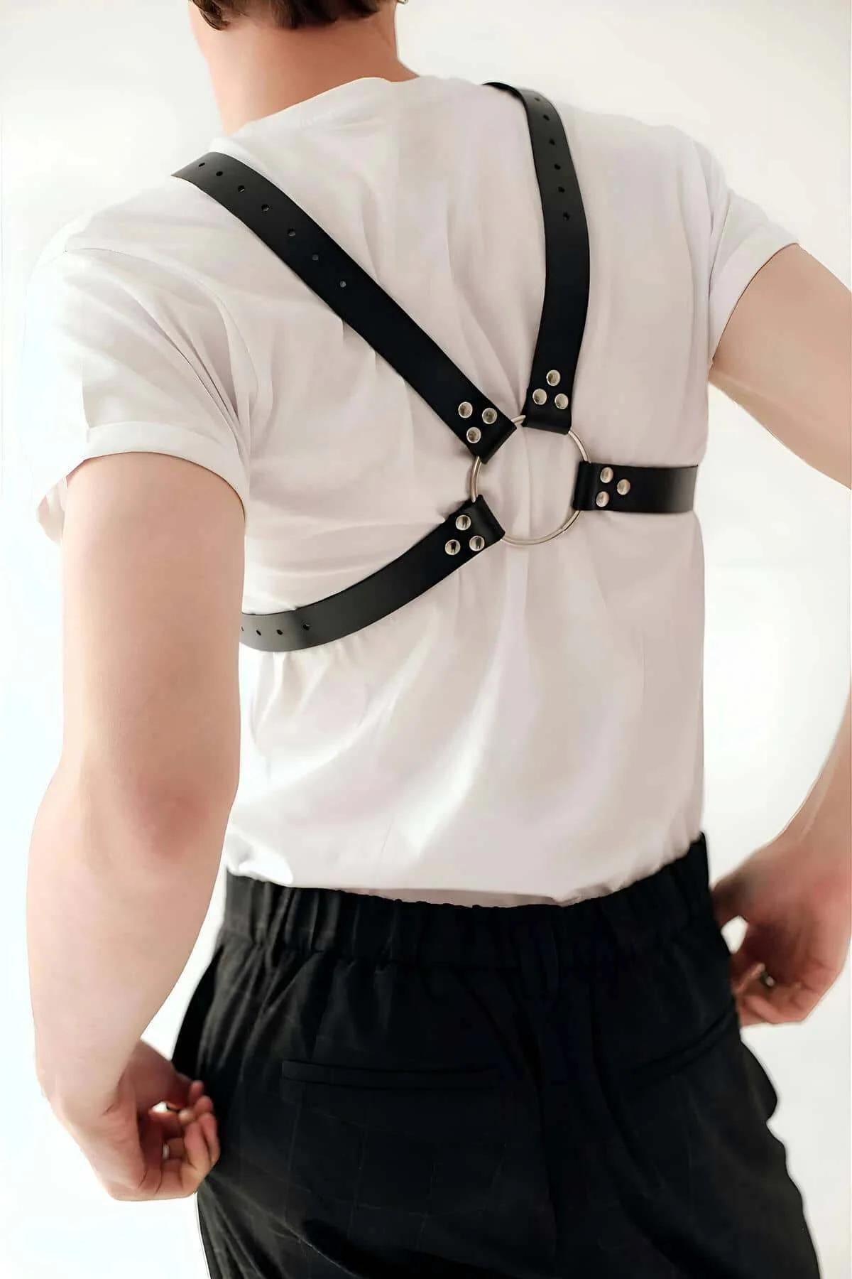 black PU leather X-strap harness with silver chain draped across torso