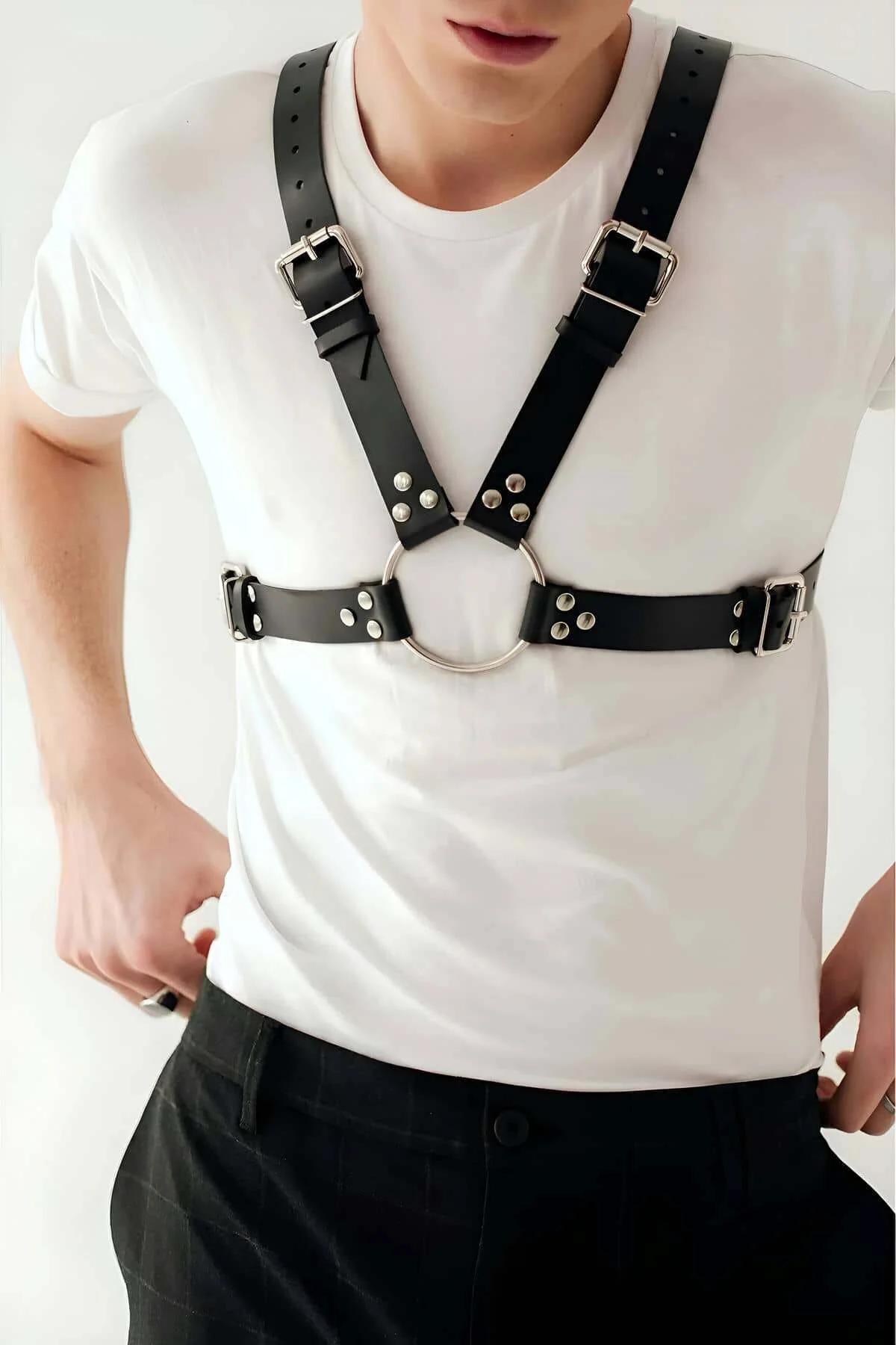 black faux leather mens chest harness styled over white fitted crew-neck tee