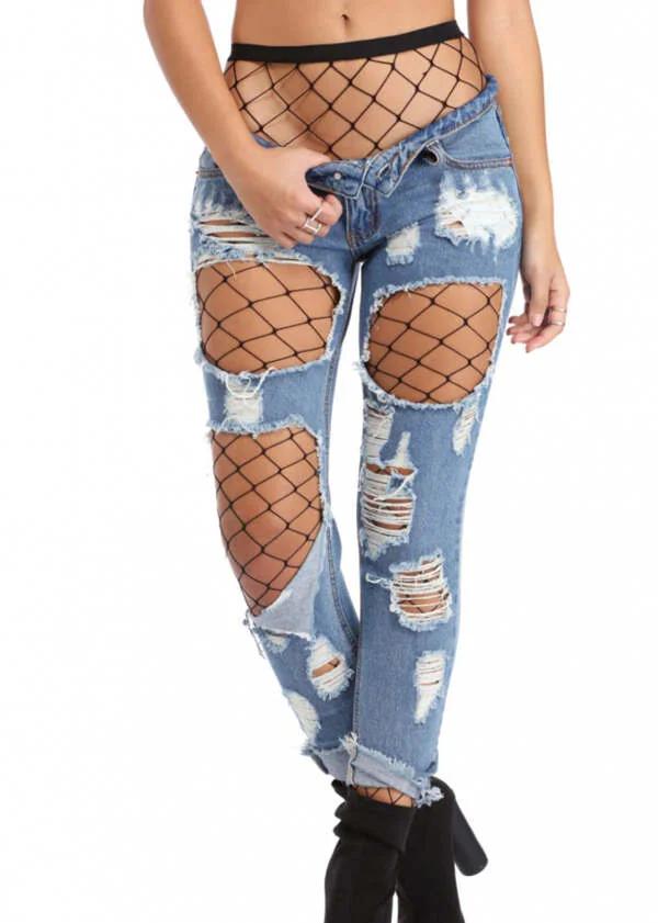 Black large-diamond fishnet pantyhose tights with elastic waistband layered under ripped light-wash jeans