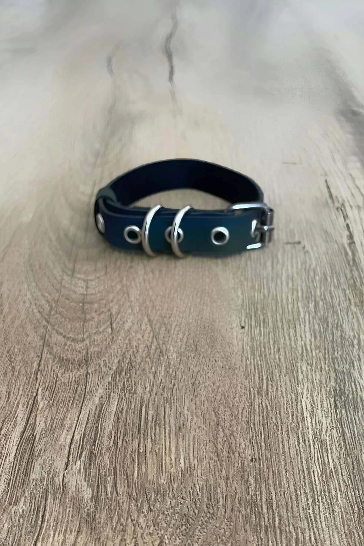 Iridescent color-shift teal to black faux leather finger harness laid flat showing full strap length