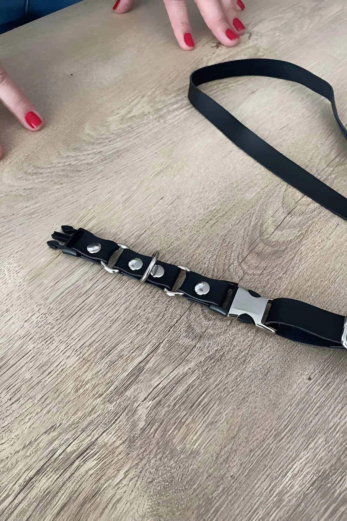 Black PU choker with multi-position snap closure and silver stud detail, close-up view