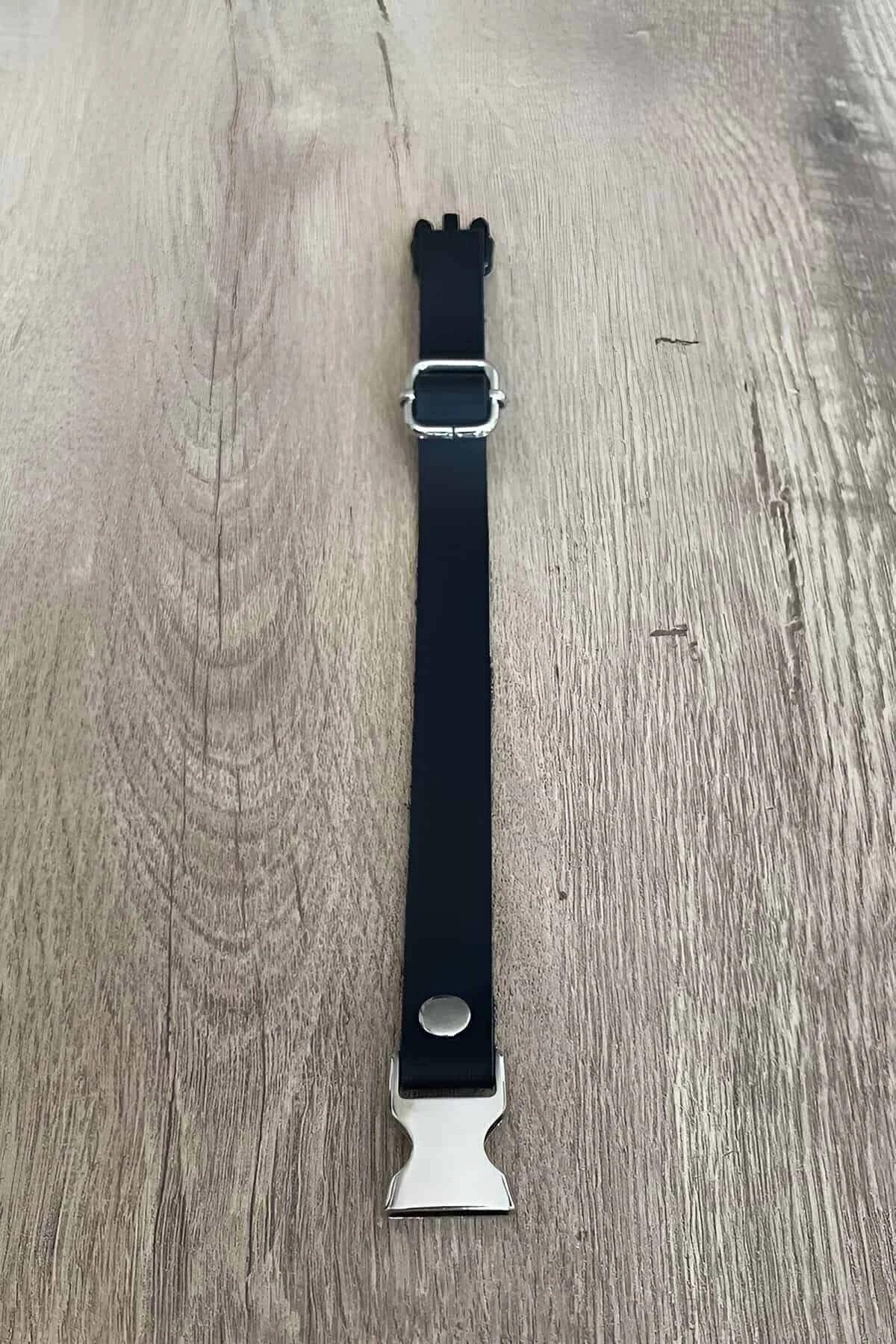 slim black faux leather collar band close-up showing silver buckle center detail
