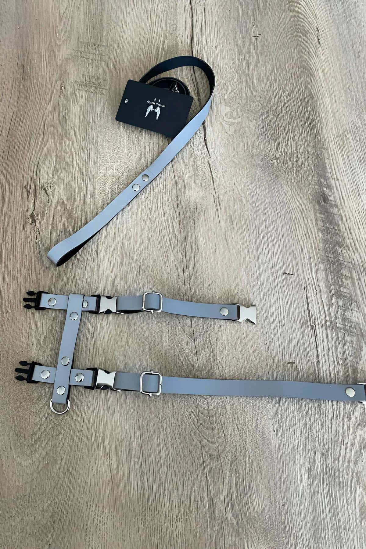 Close-up of silver retroreflective rectangular panels with circular punched eyelets on X body harness