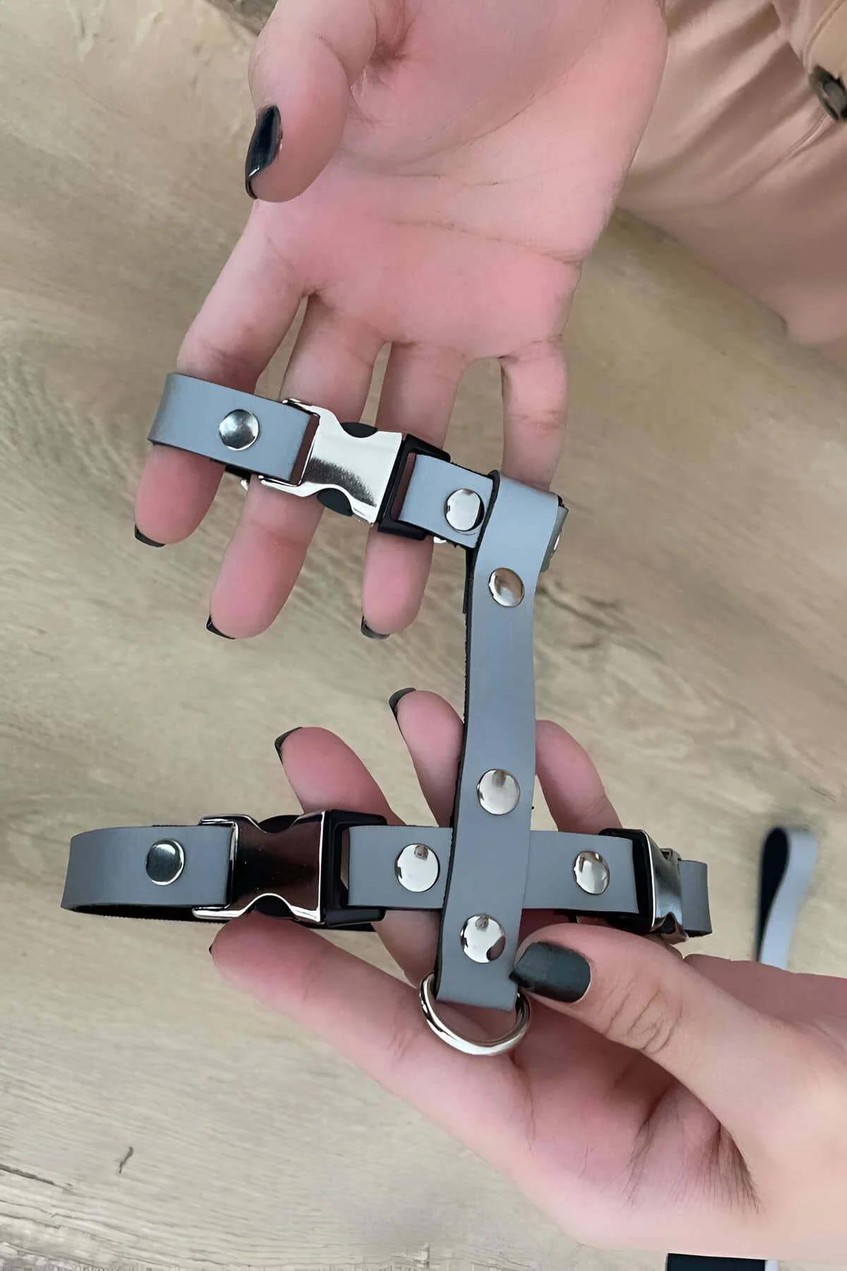 Retroreflective silver X pattern harness folded compactly showing panel and strap construction