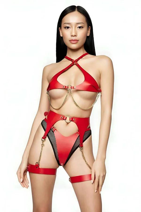 Red vegan leather halter harness set with gold chains, heart cut-out waist panel, and thigh garter bands on model