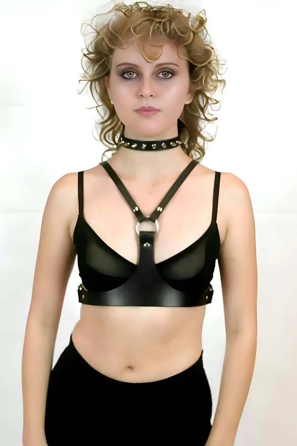 Black faux leather chest harness with silver O-ring and matching spiked choker set worn over mesh bralette