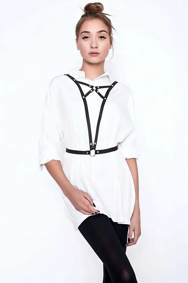 Black faux leather chest harness with silver O-ring worn over white shirt, adjustable strap style