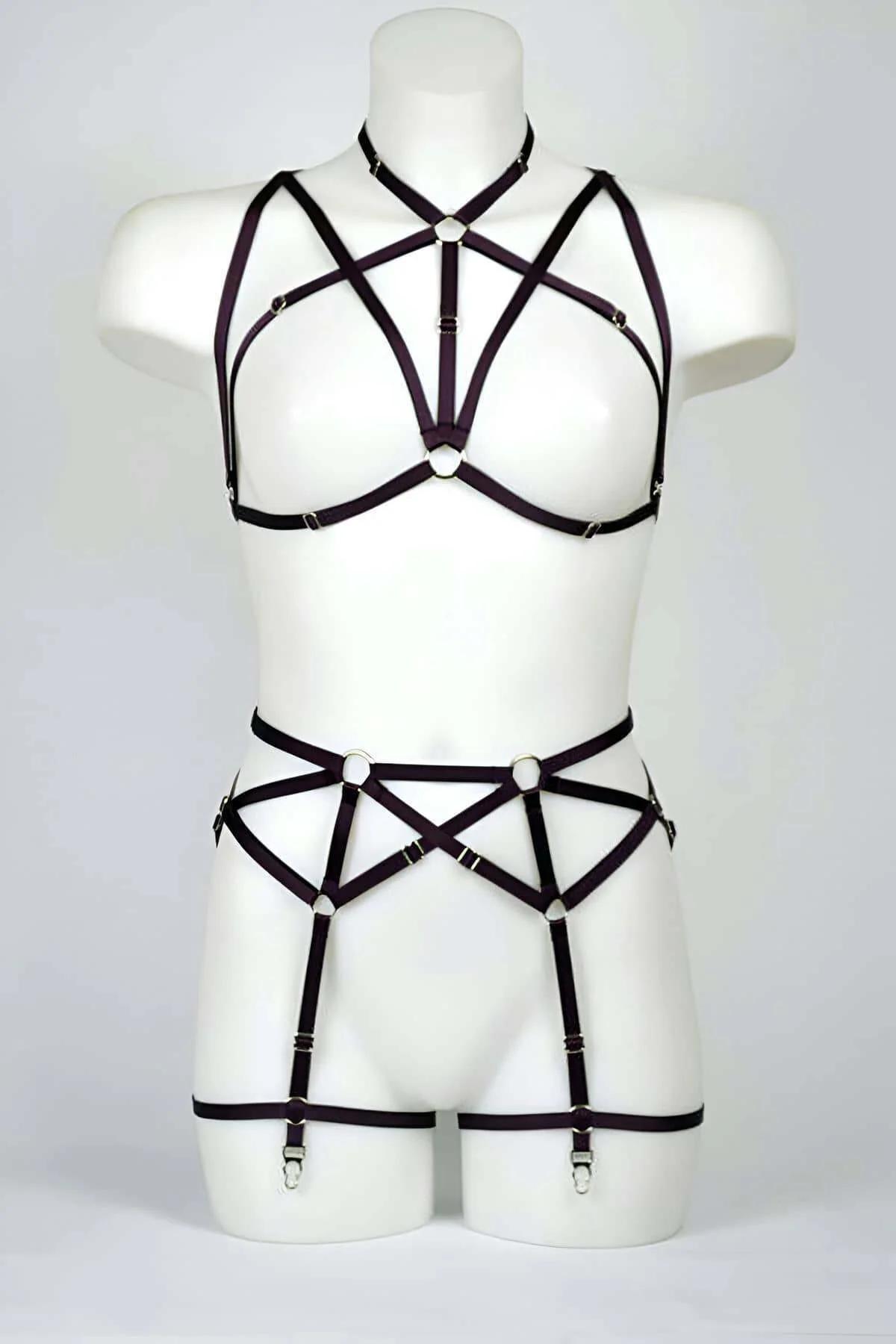 Plum elastic pentagram harness bra and garter belt set with silver O-rings and four garter clips on mannequin