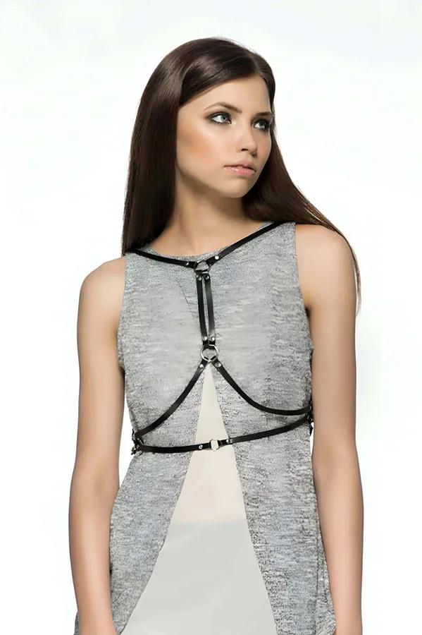 Minimalist black faux leather O-ring chest harness with slim straps and silver buckle worn over grey sleeveless dress