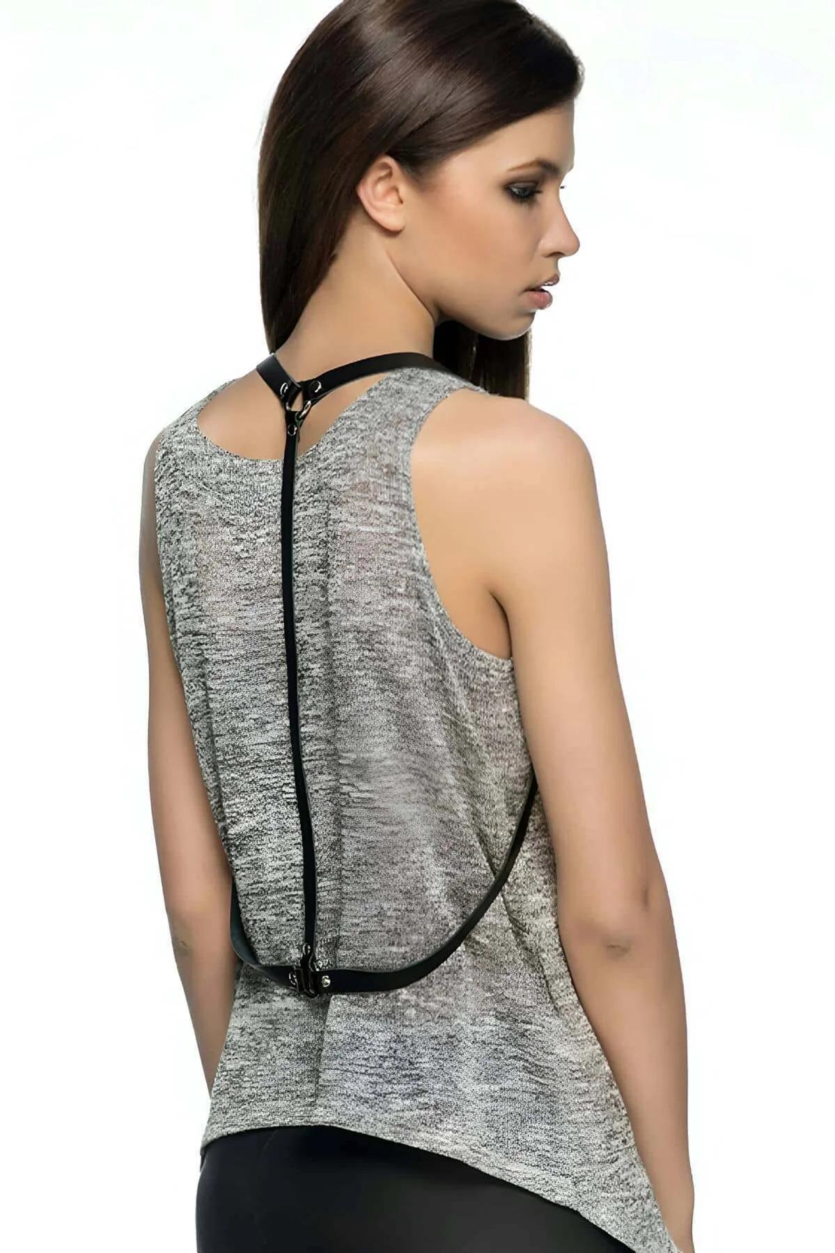 Black faux leather back body harness with silver O-ring worn over gray knit top, single vertical spine strap