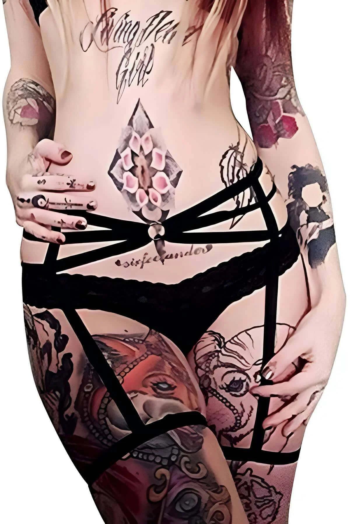 black lace-trimmed garter harness with multi-strap fan radiating from central silver O-ring at front