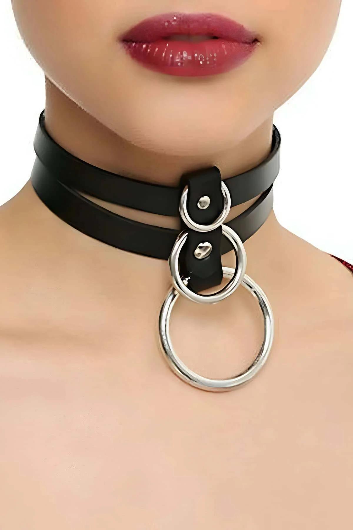 black faux leather double-strap choker necklace with three cascading silver o-rings worn on neck