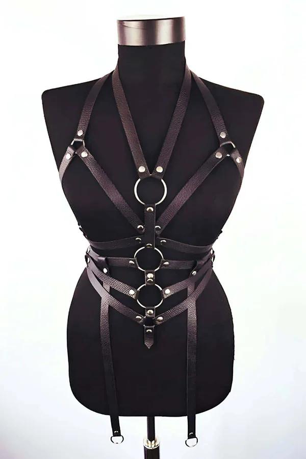 Black faux leather multi-strap body harness with three silver O-rings on dress form front view