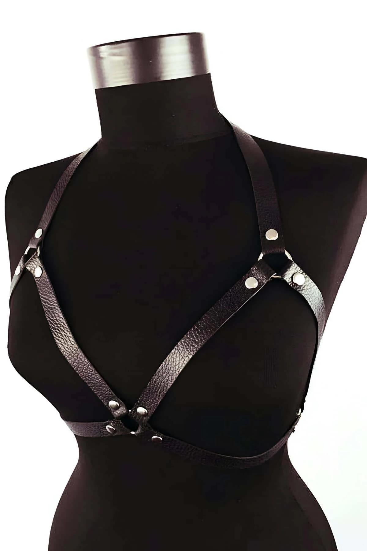 black faux leather chest harness with silver O-ring center and rivet-stud strap junctions on mannequin
