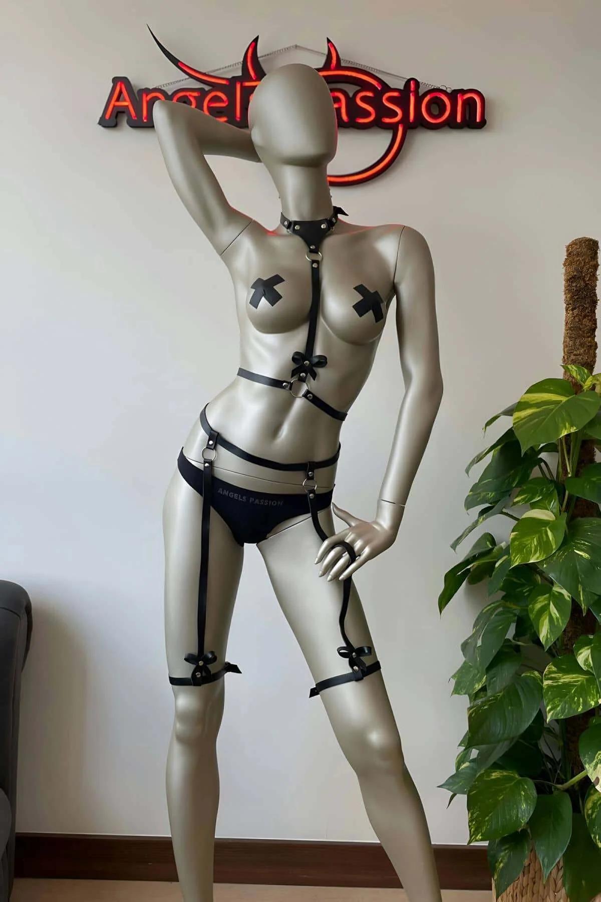 Black faux leather full body harness set with satin bow details, silver O-rings, collar, chest harness, waist belt, and thigh