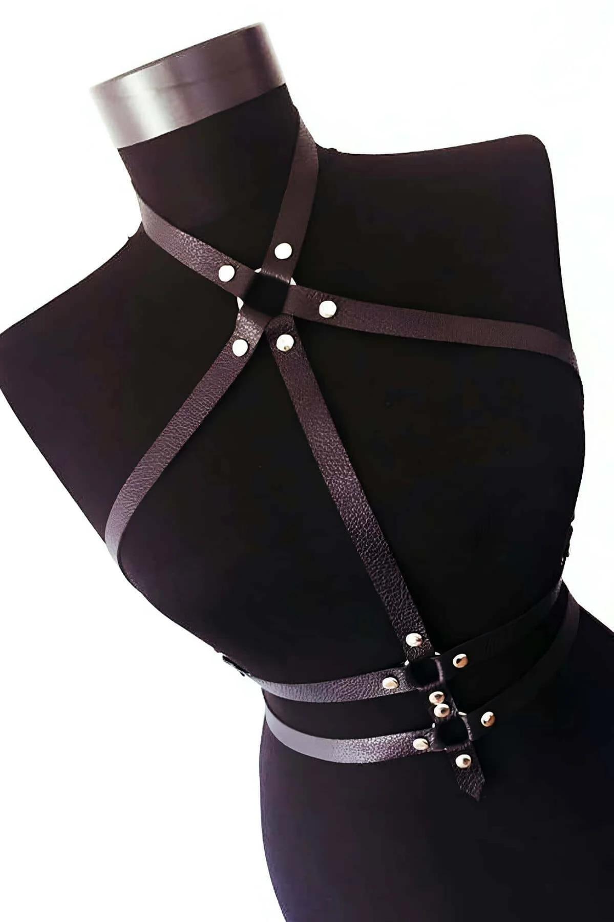 black faux leather strappy chest harness with silver O-ring accent and crossed diagonal straps on mannequin