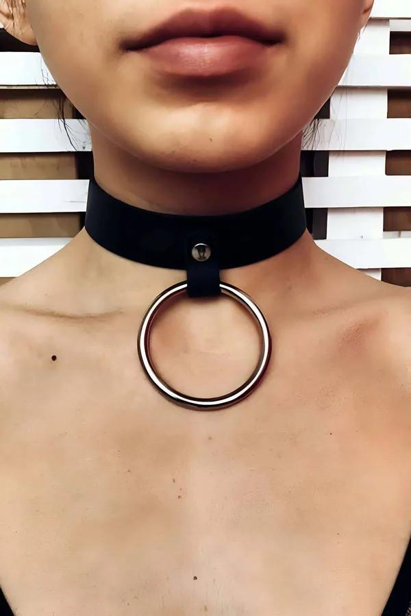 Black wide-band faux leather O-ring choker collar with gold-tone metal ring pendant on model