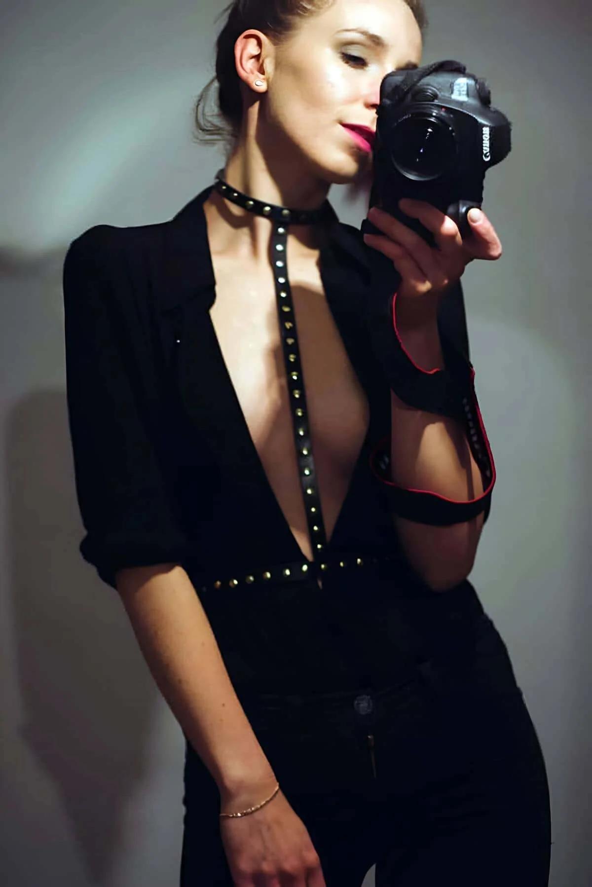 Black faux leather chest harness with gold studs choker to waist band layered over open black blazer
