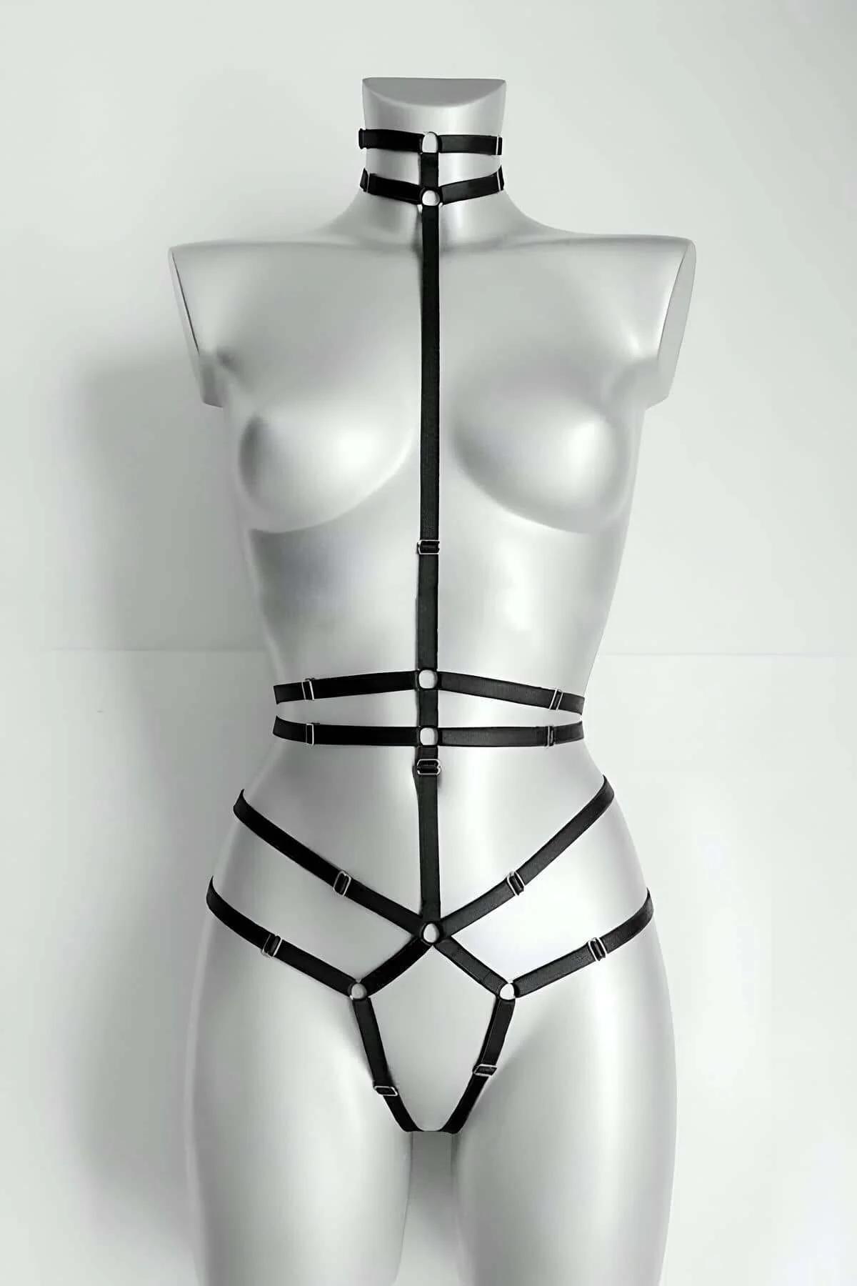 Black faux leather strappy full body harness with neck collar and silver O-rings on mannequin