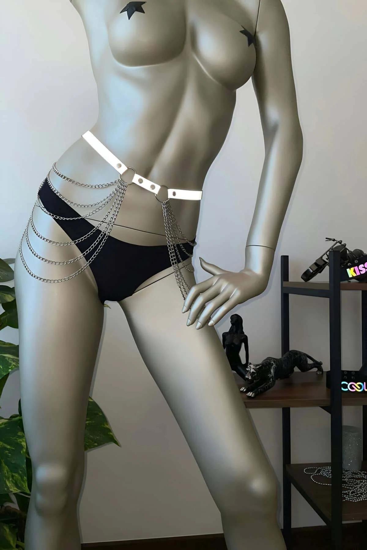 White reflective chain waist harness with silver D-rings and layered draping chains worn at natural waist
