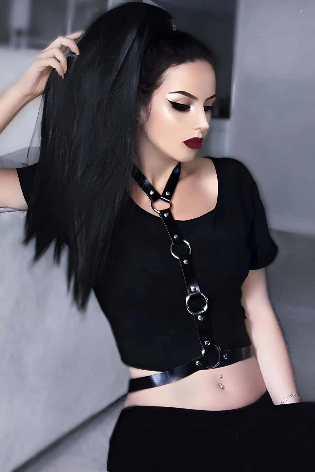 Black faux leather chest harness with three silver O-rings and vertical strap worn over black t-shirt