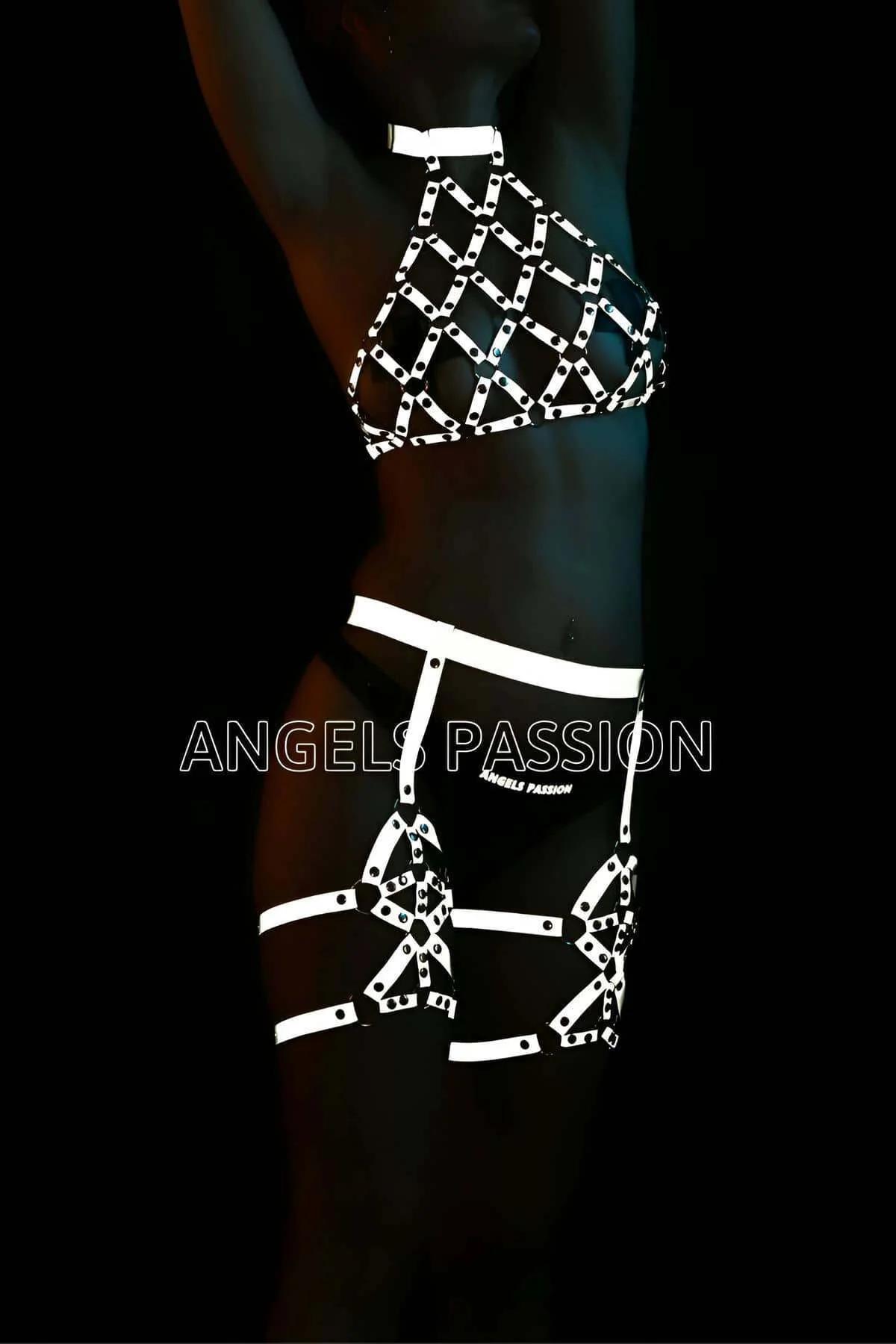 Reflective white-silver caged halter harness set with studded leg garters worn against dark background